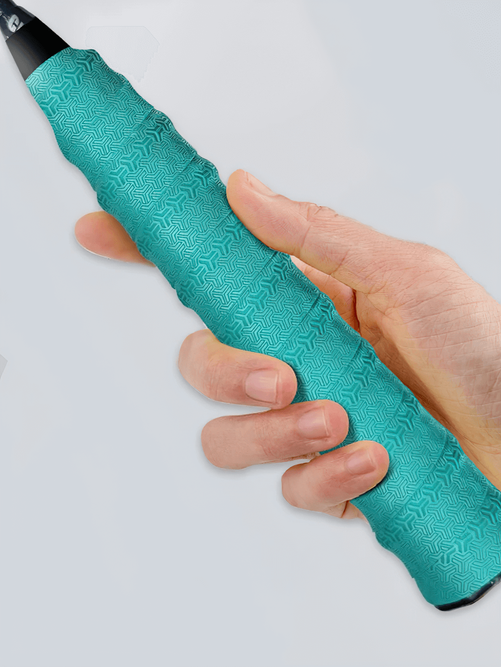 Hand holding Anti-Slip Sport Racket Overgrip Tape - SF3451 with textured turquoise design for better grip and control.